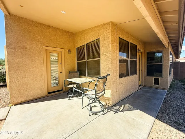 a view of a dinning room with a table and chairs