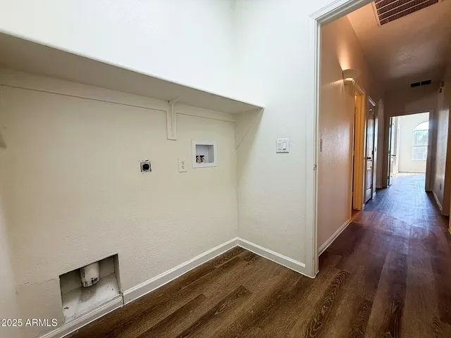 a view of hallway with wooden floor