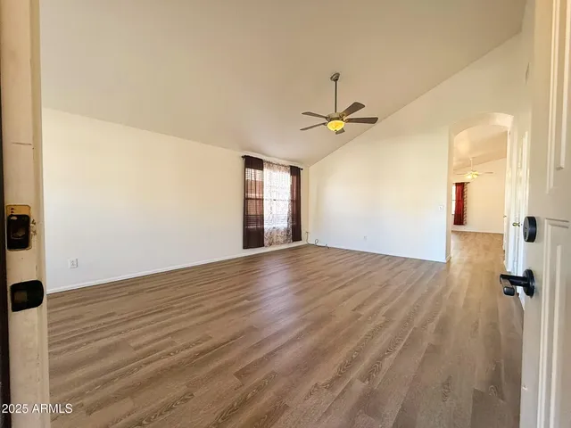 wooden floor in an empty room with a window