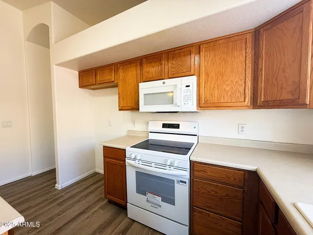 a kitchen with wooden cabinets and a stove top oven