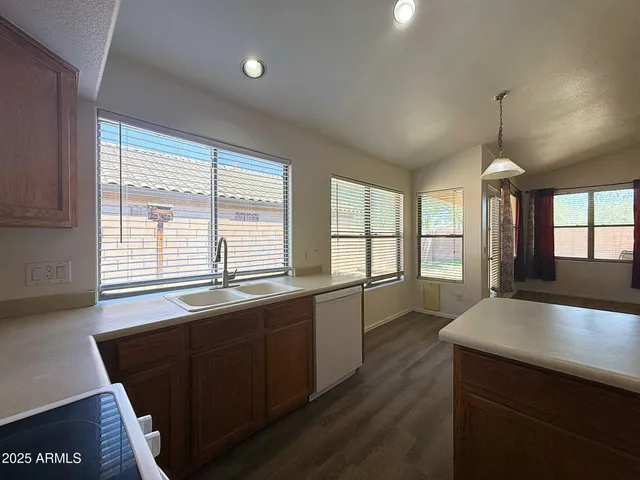 a kitchen with stainless steel appliances wooden cabinets a island and a sink
