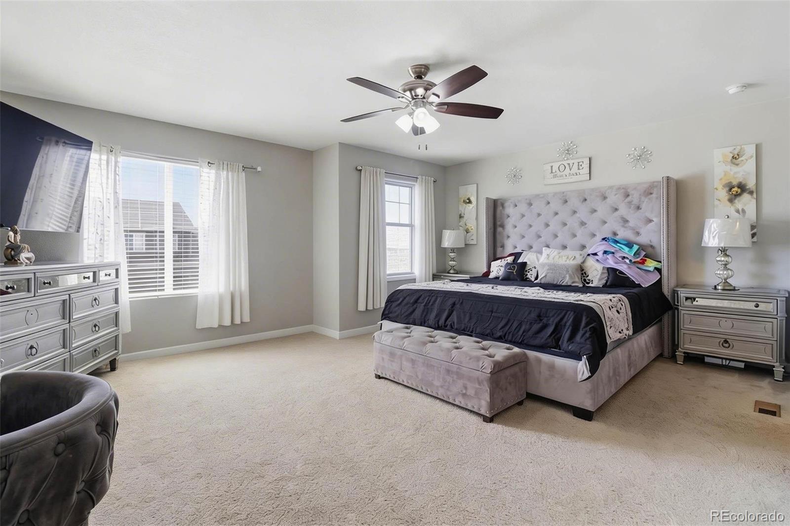 16343 East 100th Way Commerce City, CO 80022 - Photo 13 of 31 a bedroom with a bed a couch and dresser