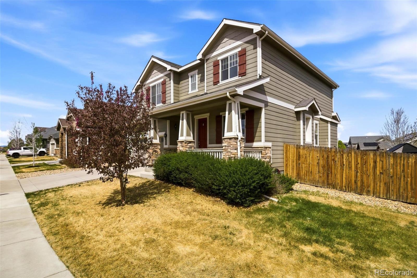 16343 East 100th Way Commerce City, CO 80022 - Photo 22 of 31 a front view of a house with a yard