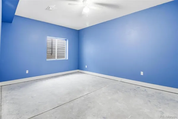 an empty room with a fan
