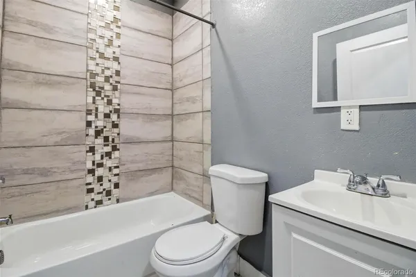 a white toilet sitting next to a bathroom sink