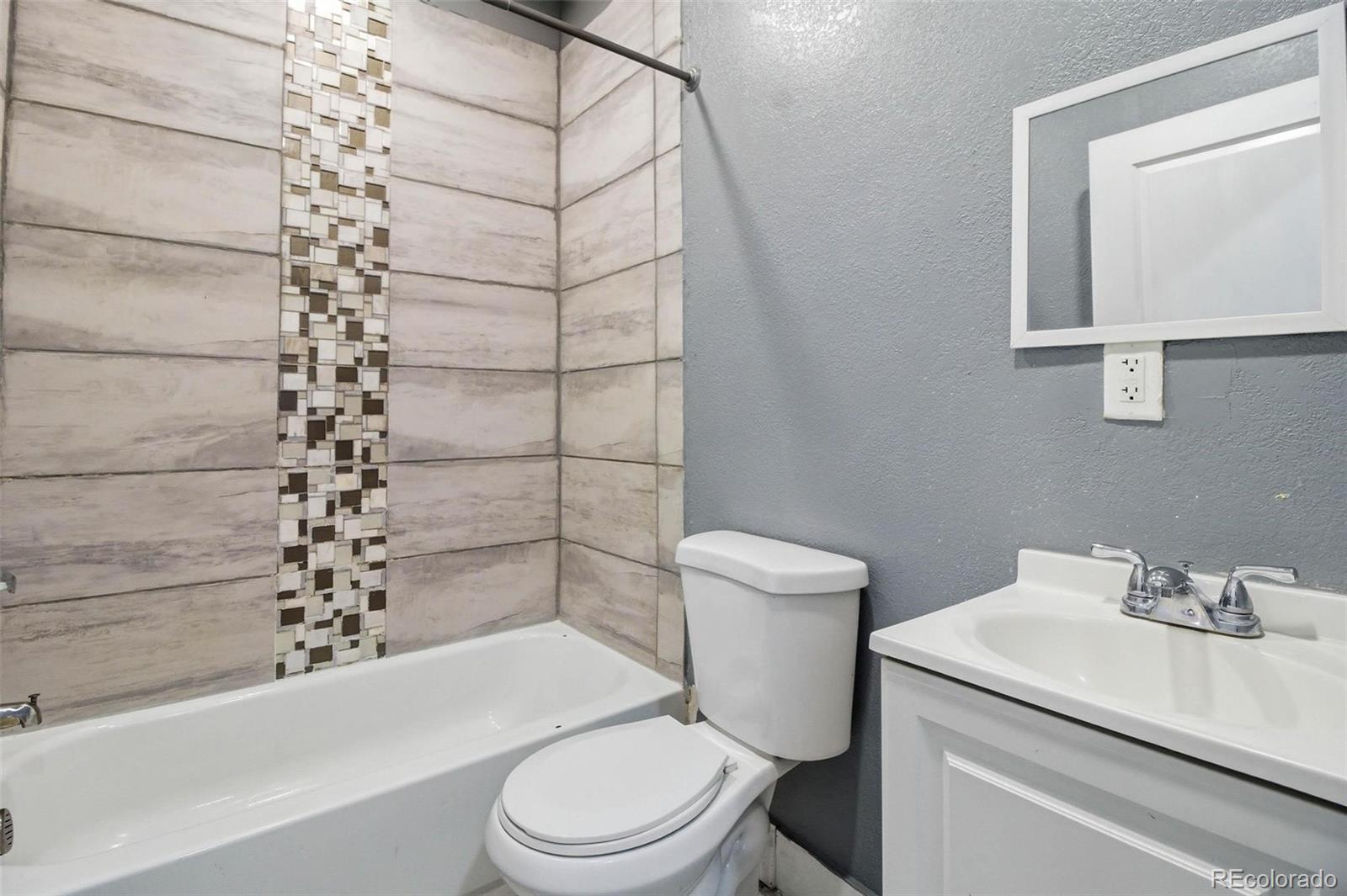 16343 East 100th Way Commerce City, CO 80022 - Photo 27 of 31 a white toilet sitting next to a bathroom sink