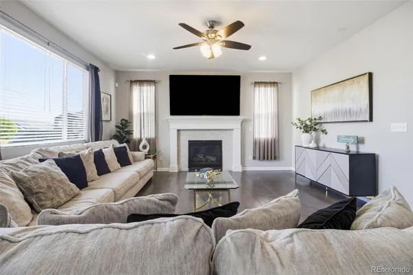 a living room with furniture fireplace and a flat screen tv