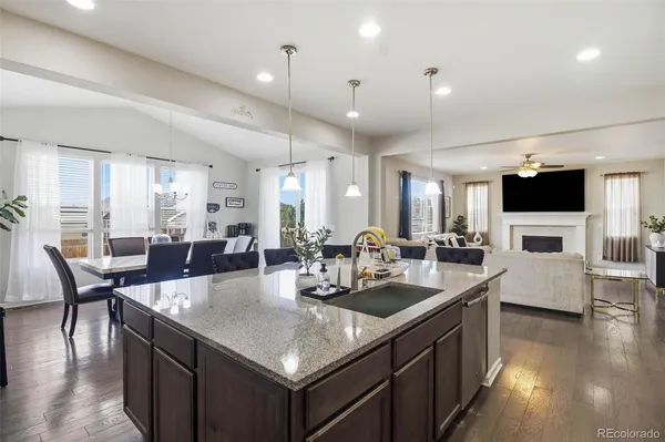 a kitchen with counter space appliances and a living room view