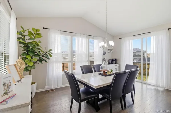 a view of a dining room with furniture window and wooden floor