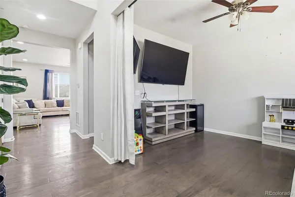 a view of a livingroom with furniture and a flat screen tv
