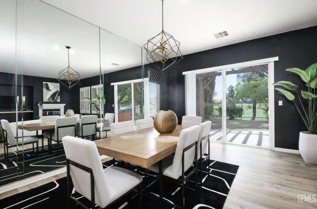 a dining room with furniture a chandelier and wooden floor