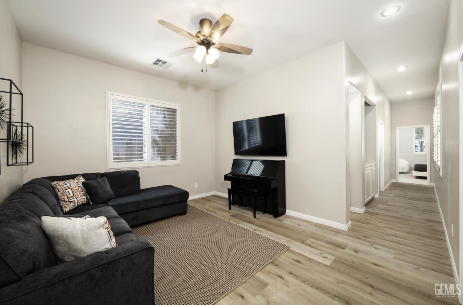 Undisclosed Address Bakersfield, CA 93312 - Photo 18 of 44 a living room with furniture and a flat screen tv