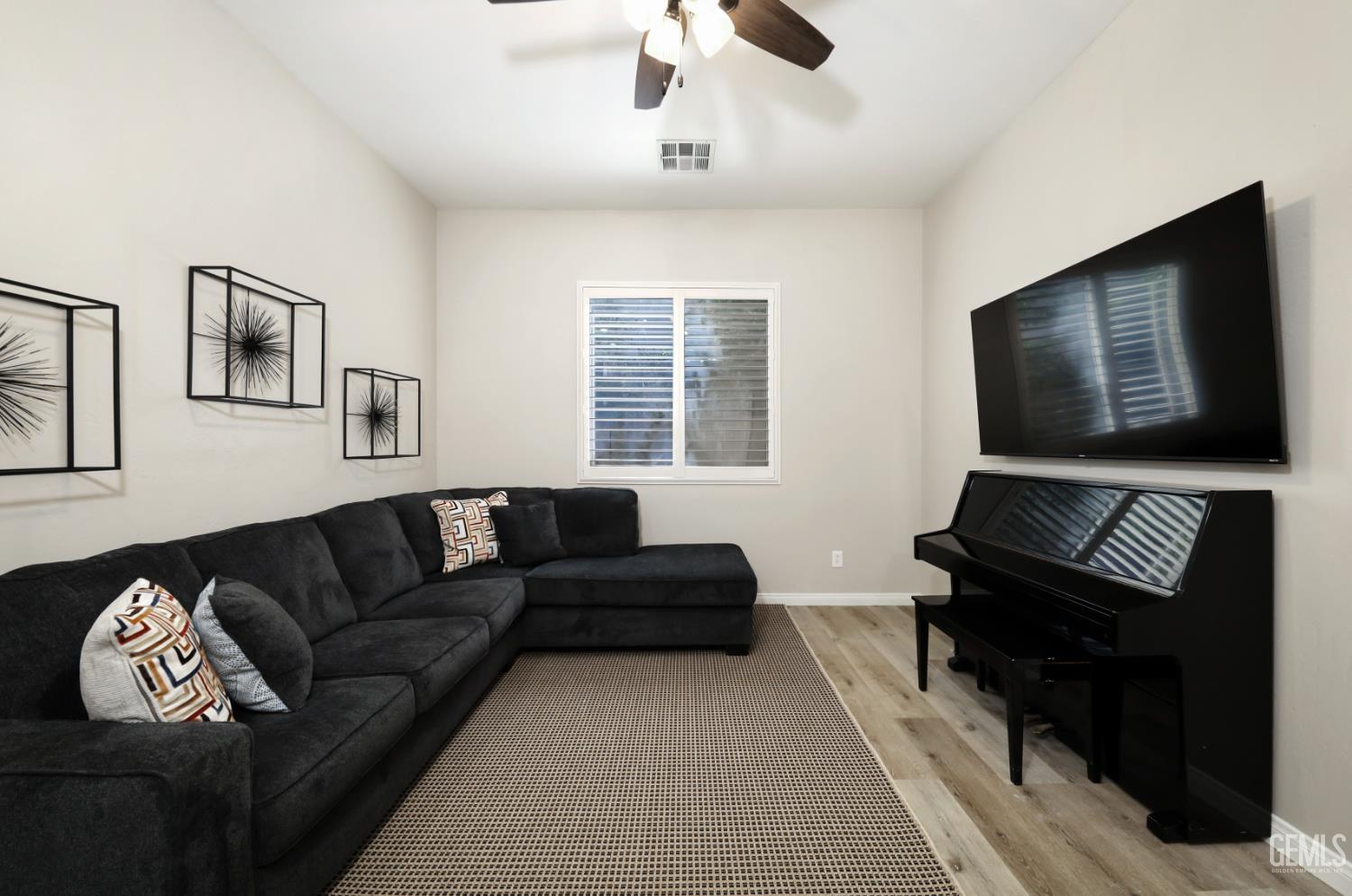 Undisclosed Address Bakersfield, CA 93312 - Photo 19 of 44 a living room with furniture and a flat screen tv