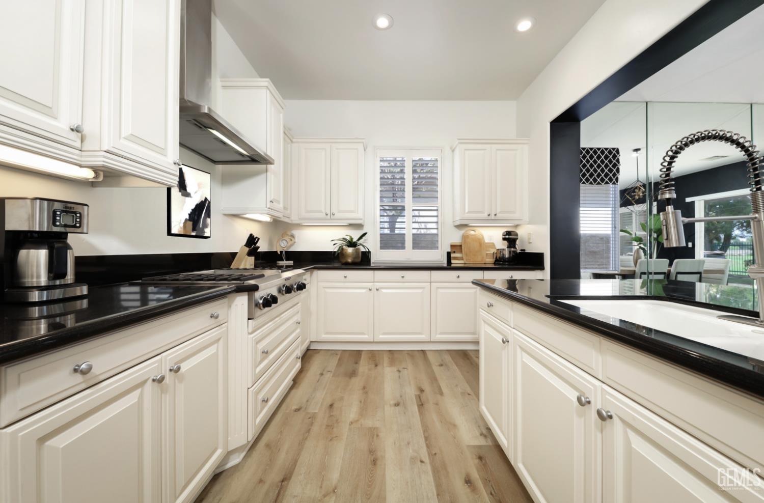 Undisclosed Address Bakersfield, CA 93312 - Photo 2 of 44 a large white kitchen with granite countertop lots of counter space a sink and appliances