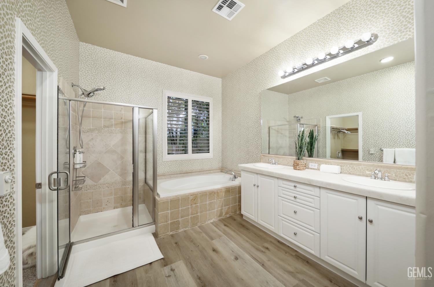 Undisclosed Address Bakersfield, CA 93312 - Photo 23 of 44 a bathroom with a double vanity sink a large mirror and shower
