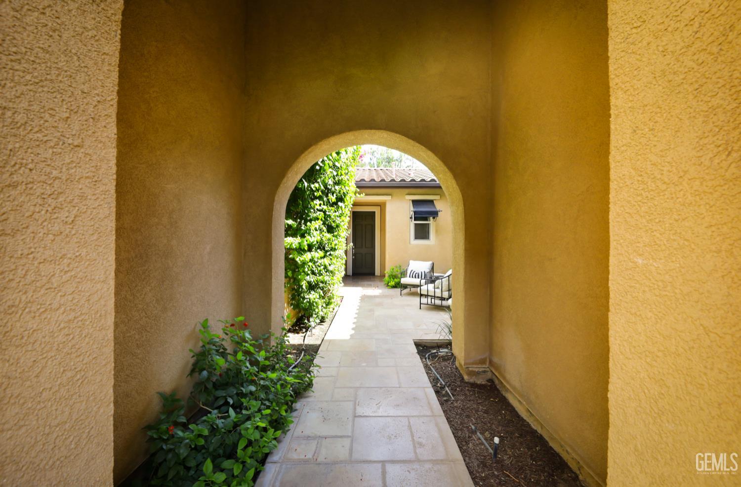Undisclosed Address Bakersfield, CA 93312 - Photo 25 of 44 a view of a brick house with potted plants