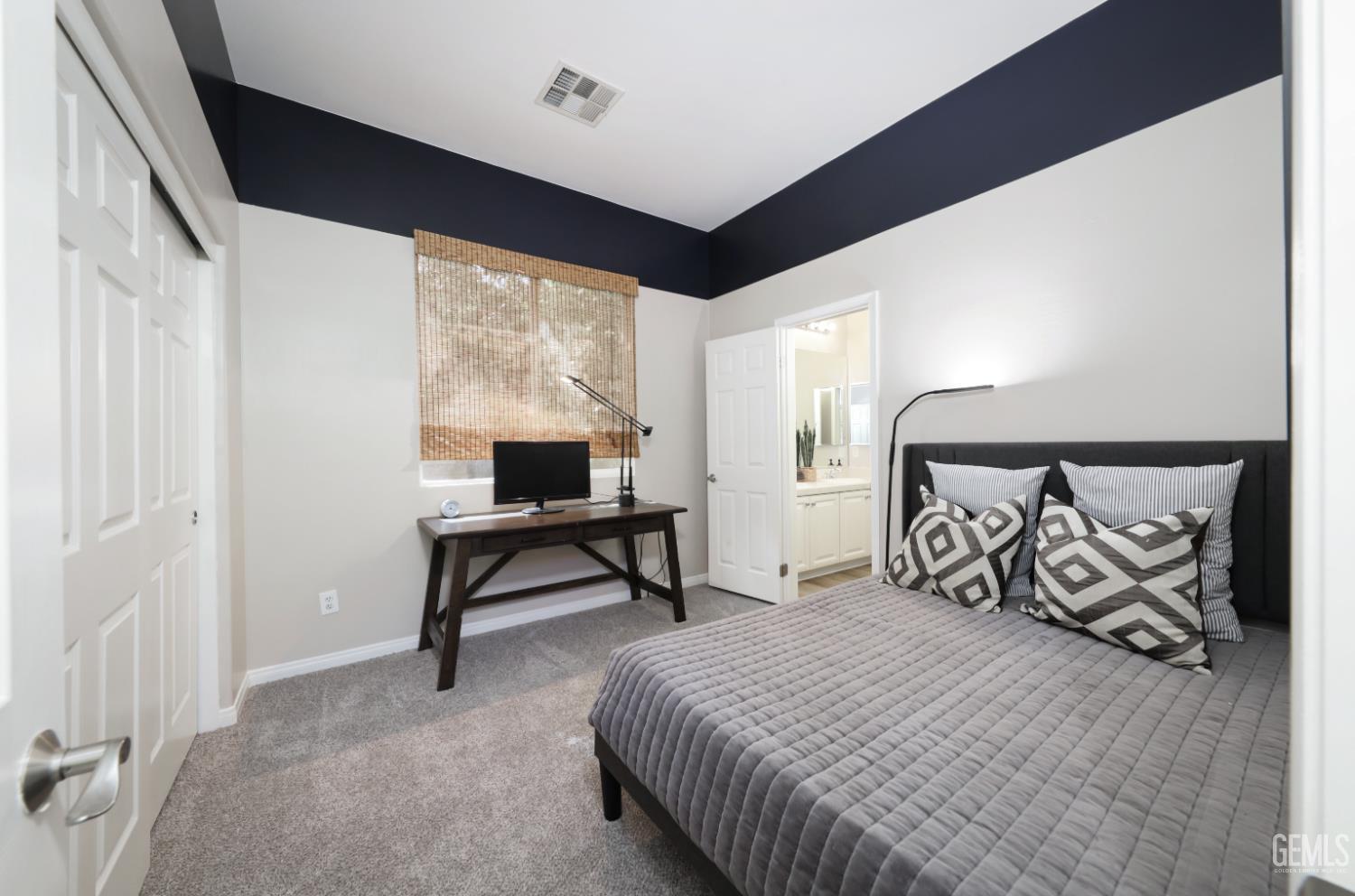 Undisclosed Address Bakersfield, CA 93312 - Photo 26 of 44 a bedroom with a bed and a table