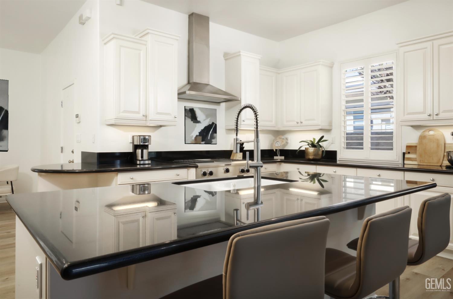 Undisclosed Address Bakersfield, CA 93312 - Photo 30 of 44 a kitchen with stainless steel appliances granite countertop a sink a stove and white cabinets