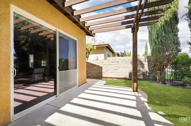 a view of a porch with furniture and garden