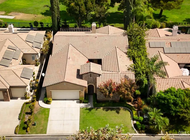 an aerial view of a house with a ocean view