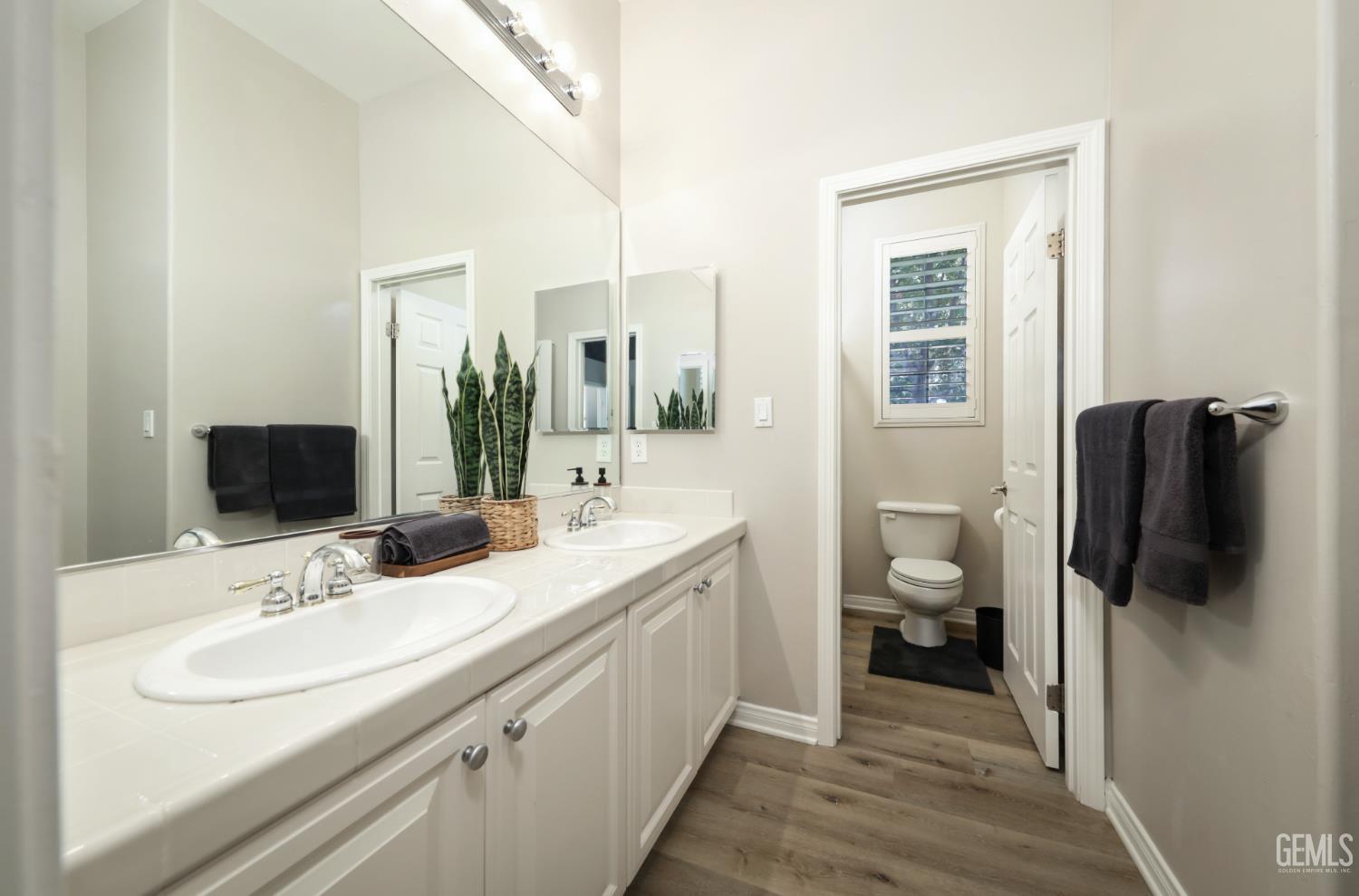 Undisclosed Address Bakersfield, CA 93312 - Photo 38 of 44 a bathroom with a sink and a mirror