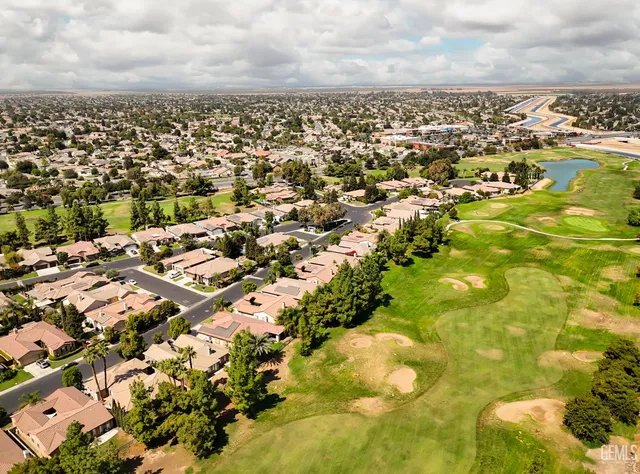 an aerial view of a residential houses with outdoor space