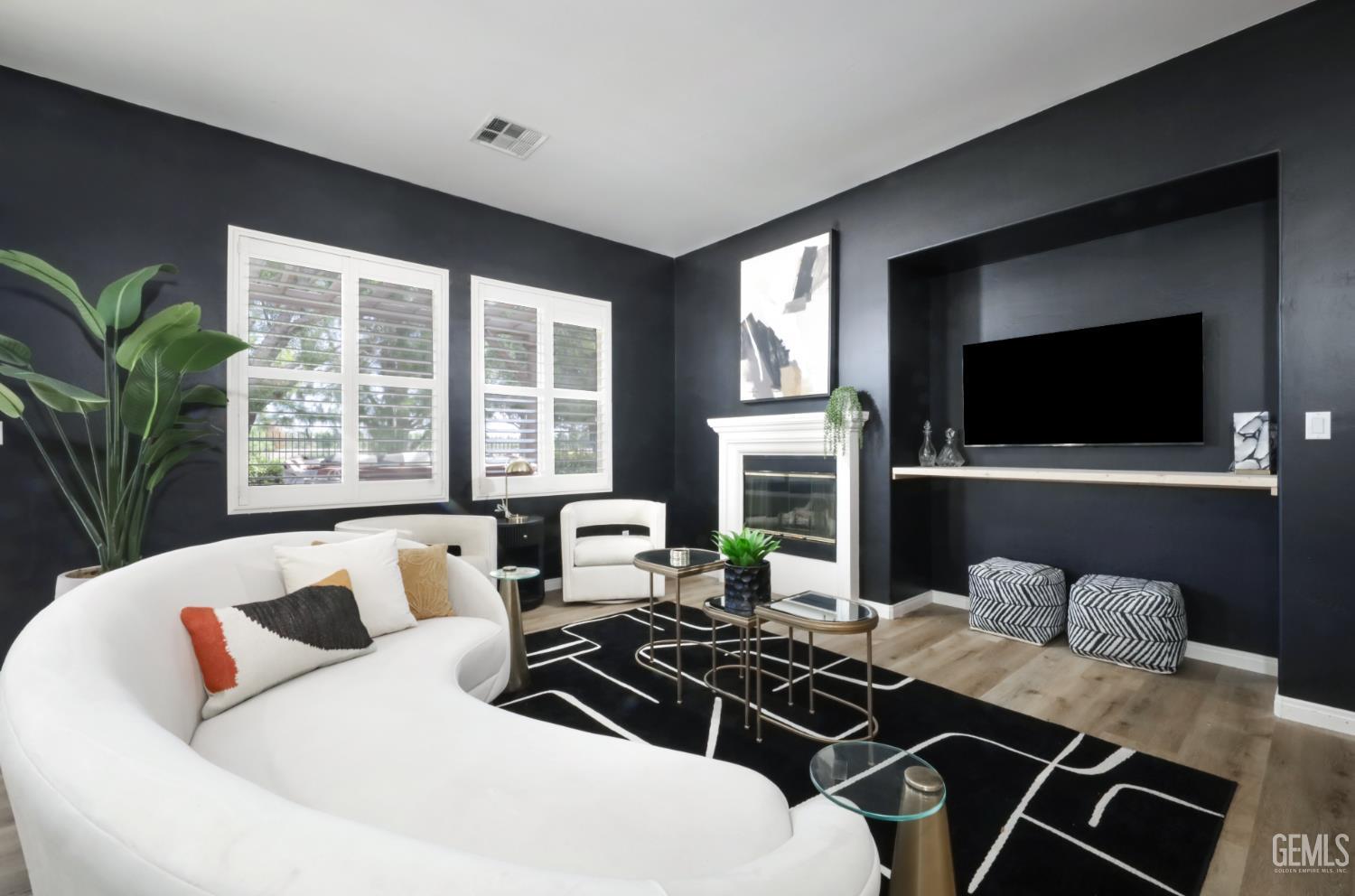 Undisclosed Address Bakersfield, CA 93312 - Photo 6 of 44 a living room with furniture a flat screen tv and a large window