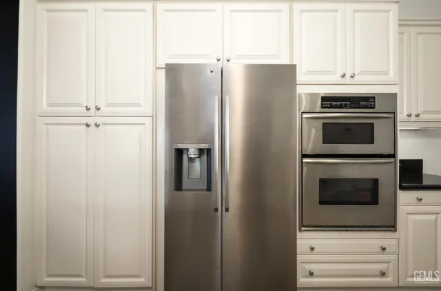 a kitchen with cabinets and stainless steel appliances