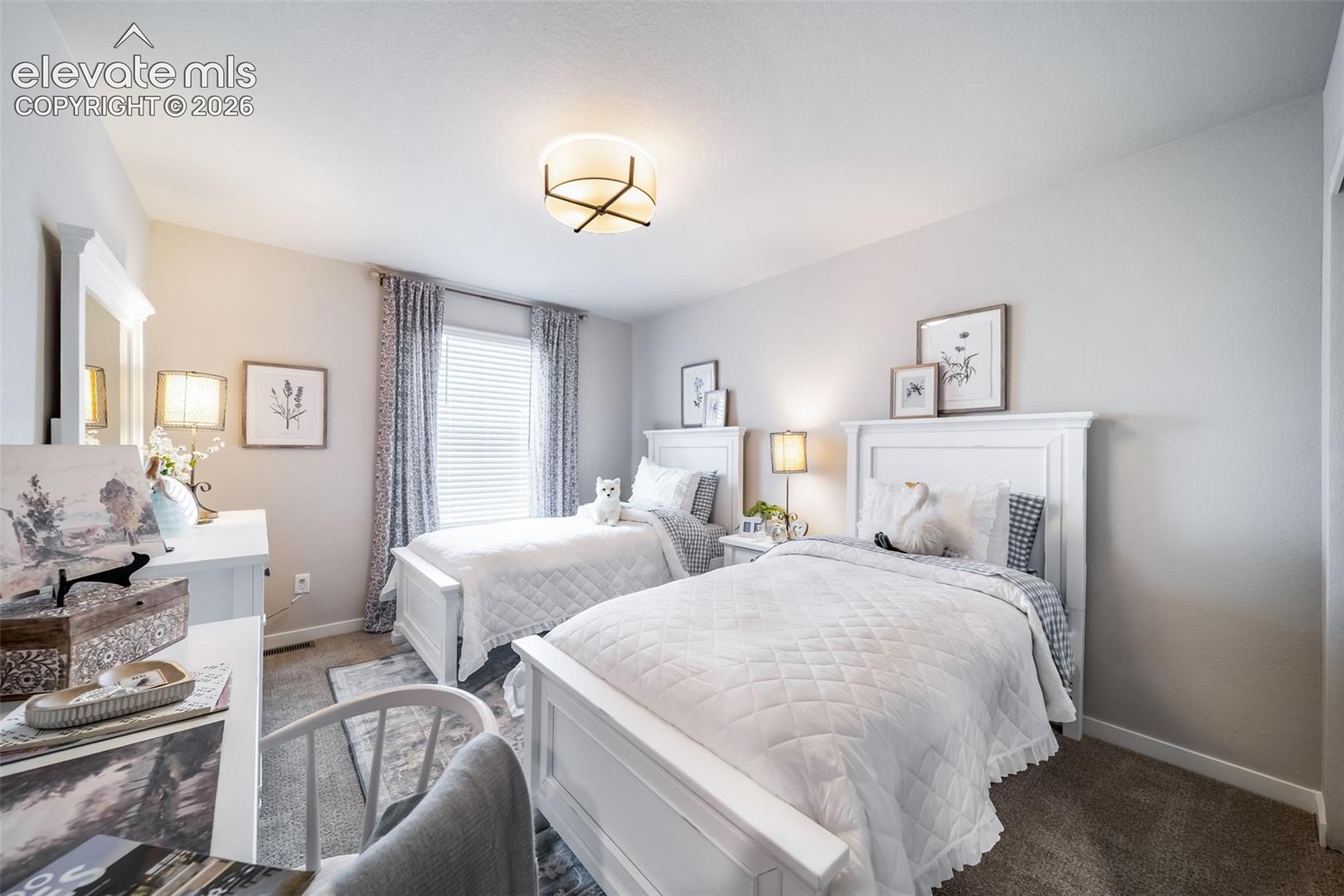 4876 Truscott Road Colorado Springs, CO 80925 - Photo 11 of 28 Carpeted bedroom with neutral wall tones and a ceiling-mounted light fixture
*Photos of a model home*