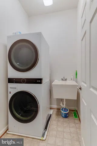 a utility room with sink dryer and washer