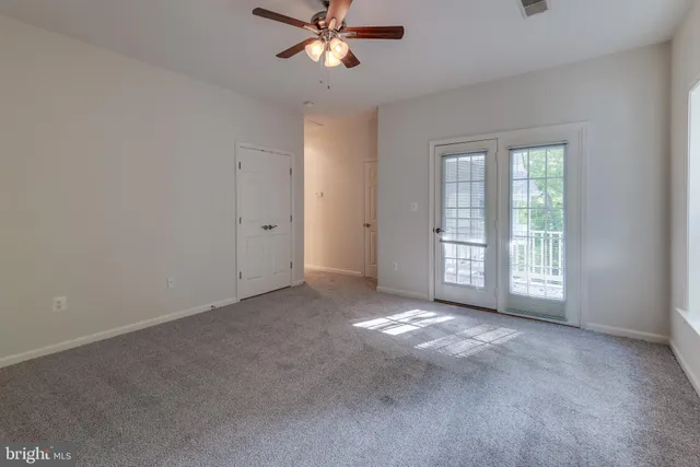 a view of a livingroom with a ceiling fan and window