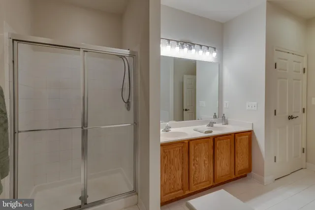 a bathroom with a double vanity sink and mirror