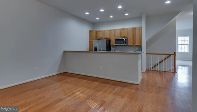 an empty room with wooden floor and a window