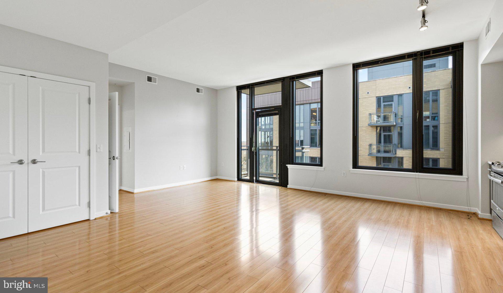 8300 Wisconsin Avenue, Unit 1B1612 Bethesda, MD 20814 - Photo 80 of 150 a view of an empty room with glass door and a window
