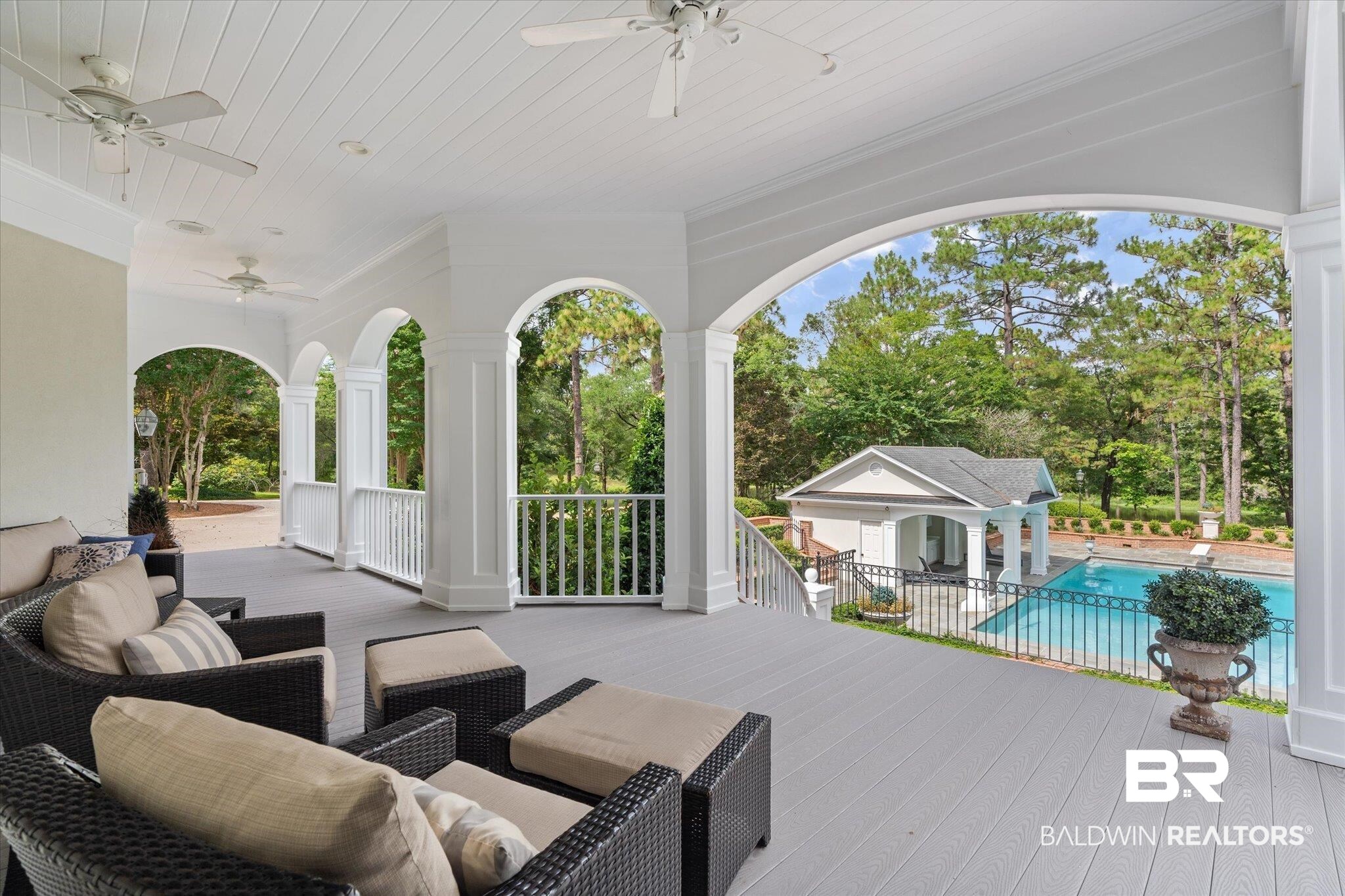 8561 Dawes Lake Road Mobile, AL 36619 - Photo 39 of 63 Wooden deck featuring ceiling fan, an outdoor pool, and view of wooded area