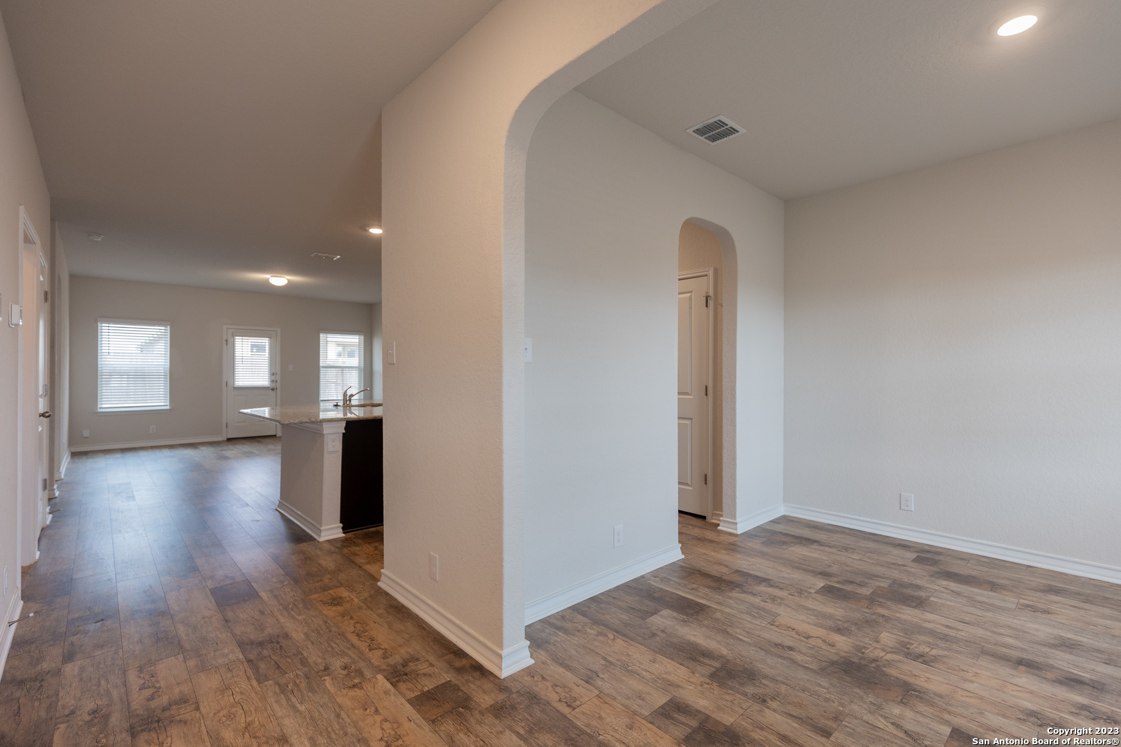 9819 Bratten Rise San Antonio, TX 78254 - Photo 4 of 37 a view of a room with wooden floor and stairs