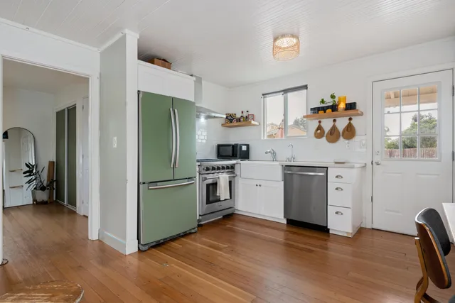 a kitchen with a refrigerator and a sink