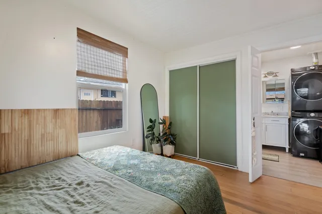 a bedroom with a bed and a window