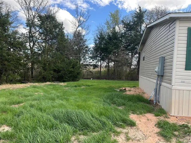 a view of a backyard with small cabin