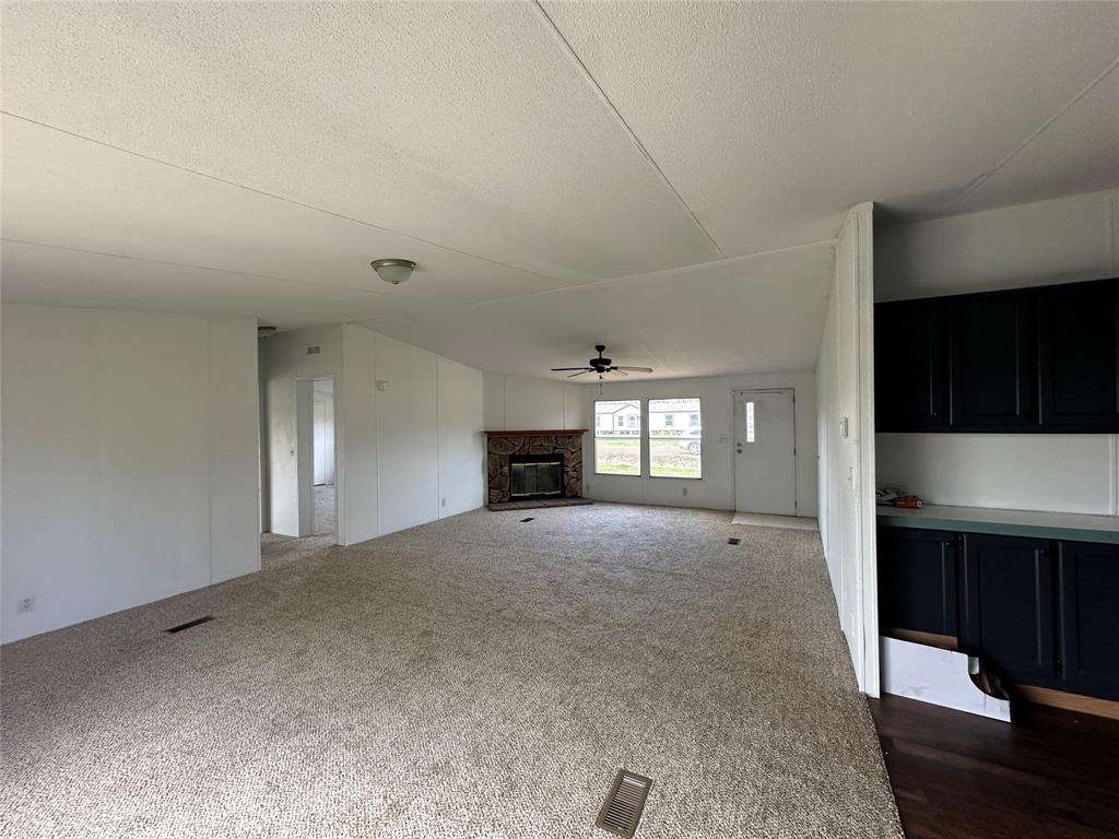 230 Largo Street Bonham, TX 75418 - Photo 18 of 34 a view of empty room with a fireplace and window
