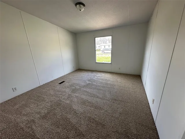 a view of an empty room and a window