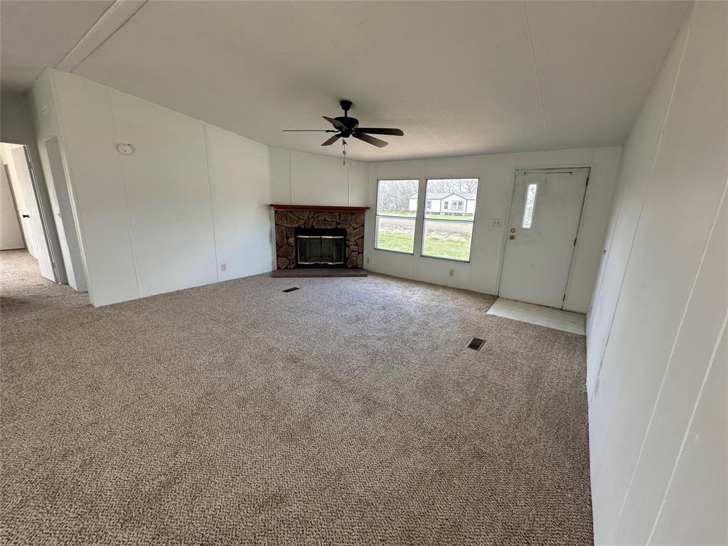 230 Largo Street Bonham, TX 75418 - Photo 30 of 34 an empty room with windows and ceiling fan