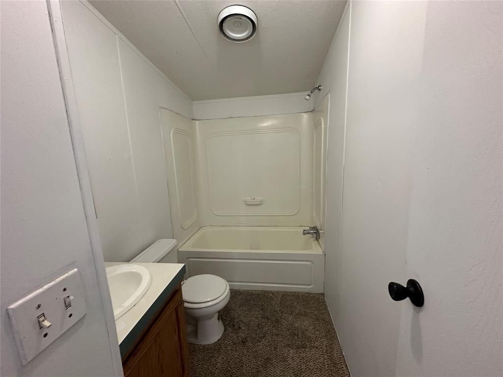 230 Largo Street Bonham, TX 75418 - Photo 31 of 34 a bathroom with a sink a toilet and shower