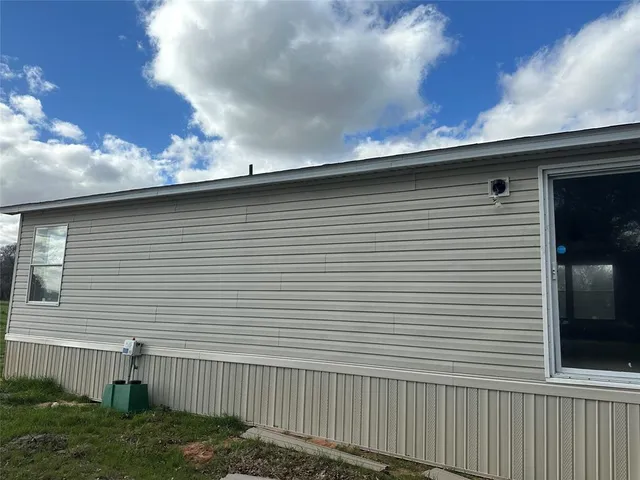 a side view of a house with a yard
