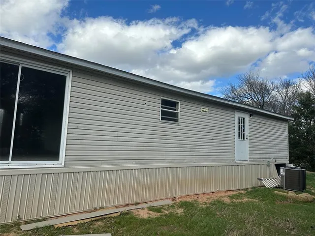 a side view of a house with a yard