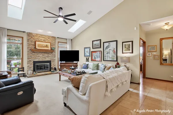 a living room with furniture a flat screen tv and a fireplace