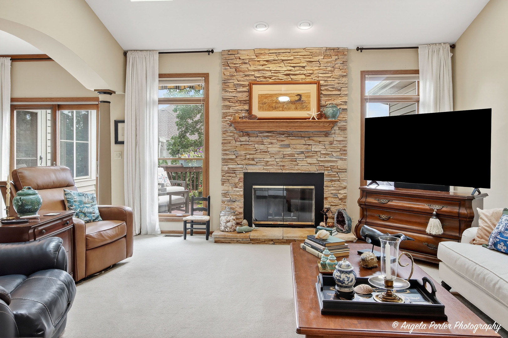 10910 Partridge Trail Richmond, IL 60071 - Photo 12 of 62 a living room with furniture a flat screen tv and a fireplace