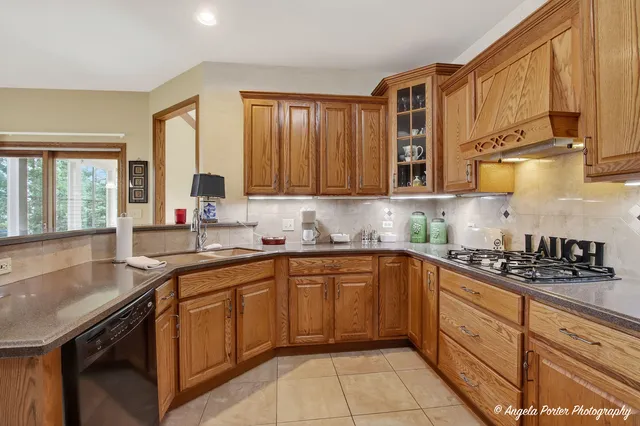 a kitchen with granite countertop a refrigerator and cabinets