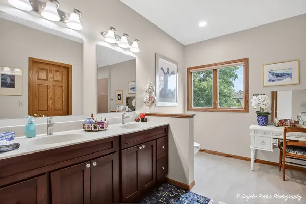 a bedroom with a bed a couch and dresser