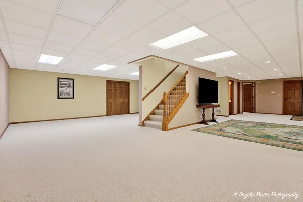 a front view of a house with a yard and trees